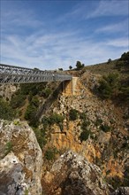 An iron bridge spans a gorge under a blue sky, Aradena Gorge, Aradena, Sfakia, Crete, Greece,