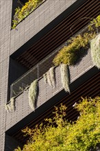 Facade of a modern building with balconies and plants in the Poblenou district in Barcelona in