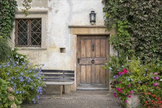 House entrance with lush floral decorations, Mitterdorf, Kaltern, South Tyrol, Trentino-South Tyrol