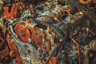 Close-up of a rusted and damaged engine with clearly visible metal parts, abandoned A4 motorway,