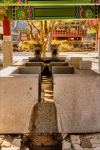 Covered water cistern with dragon head fountains at Buddhist temple