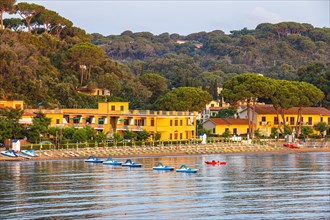 Pedal boats, sun loungers and parasols on the beach at Naregno at sunrise, near Capoliveri, Elba,