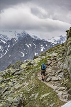 Two mountaineers on a hiking trail, view of glaciated rocky mountain peaks, Berliner Hoehenweg,