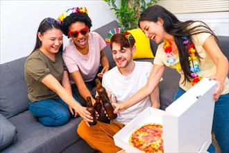 Friends celebrating birthday with pizza and beer toasting together in the living room