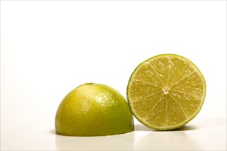 Closeup of a fresh lime cut in half isolated on white background and copy space
