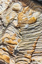 Coloured, ferruginous mineral sandstone on Topinetti beach, near Rio Marina, Elba, Tuscan