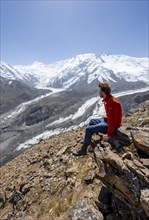 Mountaineer at Traveller's Pass with view of impressive mountain landscape, high mountain landscape