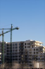 Construction cranes of new apartment buildings in Barcelona in Spain