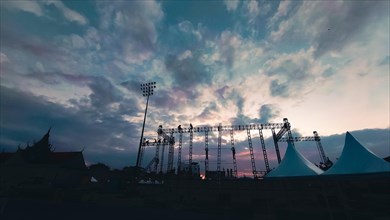 A stadium under a dramatic sky at sunset