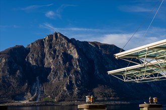 Modern Building Roof Against Blue Sky and Mountain Peak San Salvatore on Lake Lugano in Campione