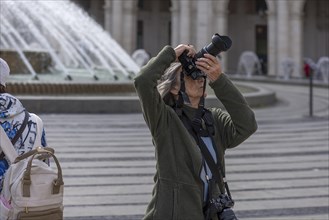 Photographer taking pictures in the Piazza de Ferrari, Genoa, Italy, Europe
