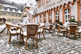 Heidelberg, Germany, February 2020: Empty tables with chairs covered in snow in front of outdoor