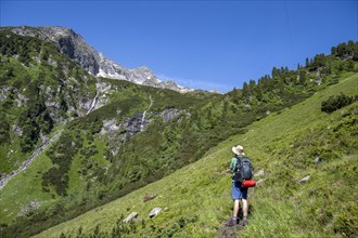 Mountaineer in front of mountain landscape, waterfalls of the Kesselbach, rocky mountain peaks,