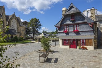 Rue du General de Gaulle in the old town centre of Le Faou with slate-roofed granite houses from