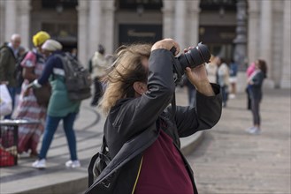 Tourist taking photos in the Piazza de Ferrari, Genoa, Italy, Europe