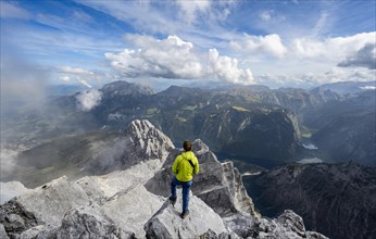 Mountaineer on the rocky summit of the Watzmann Mittelspitze, Watzmann crossing, view of mountain