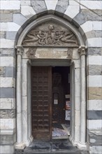 Side portal of the Romanesque Chiesa Parrocchia Abbazia di San Stefano, mentioned in 920, Piazza