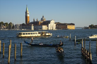Gondolas on the promenade of the Riva degli Schiavon with a view of San Giorgia Maggiore, Venice,
