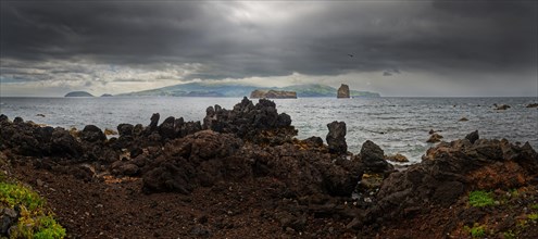 Panoramic view of the sea with the island of Faial and dramatic dark clouds, Madalena, Pico,