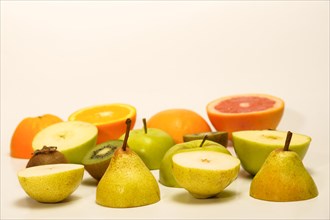 Fresh fruit cut in half isolated on a white background.pear, kiwi, apple, orange, grapefruit