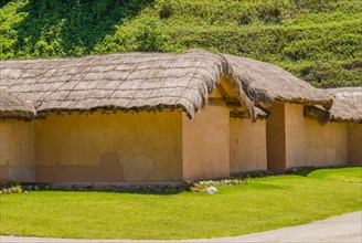 Buildings with straw thatch roofs in public park