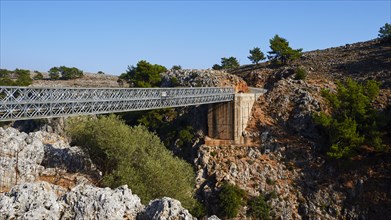 A bridge connects two rocky hills in a natural landscape, Aradena Gorge, Aradena, Sfakia, Crete,
