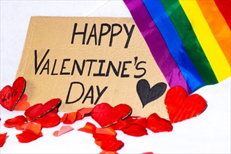 Cardboard sign Happy Valentine's Day lgbtq+ isolated. Text of Happy Valentine's Day written on a