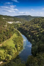 River with gorge and autumnal coloured forest, valley of the Loue, Lizine, near Besancon,