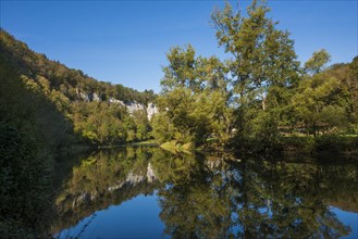 River with gorge and autumnal coloured forest, valley of the Loue, Lizine, near Besancon,