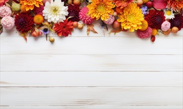 Colorful autumn flowers arranged on a white wooden background with space at the top AI generated