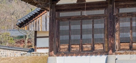 Oriental lattice work on doors of wooden building in a local woodland park in South Korea