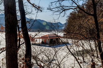 Goesan-gun, South Korea, Jan. 20, 2021: Winter landscape of fishing hut docked on frozen snow