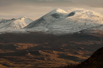 Snow-covered mountain peaks in autumn near Abisko National Park, northern Sweden, Lapland