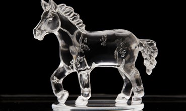 White horse running on the snow in winter. ice sculpture. glass figure of horse in dynamic pose AI