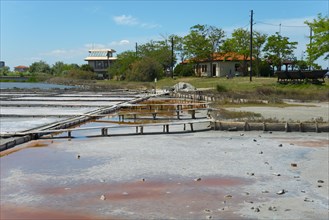 Salt extraction plant with natural landscape in the background and a clear blue sky, therapeutic