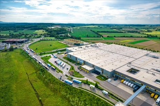 Aerial view of an industrial area with large warehouses and surrounding fields, Amazon, Pforzheim,