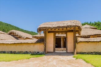 Buyeo, South Korea, July 7, 2018: Front gate of Korean village with building built of wood and