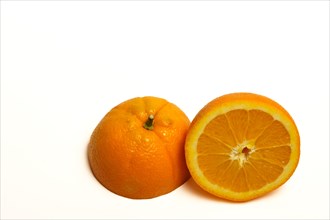 Closeup of a fresh orange cut in half isolated on white background and copy space