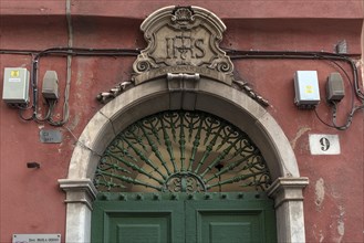 Detail of a decorative entrance door in the historic centre, Genoa, Italy, Europe