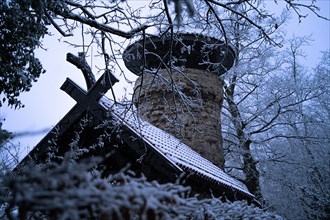 Snow-covered tree house surrounded by trees in a wintry atmosphere, Hachelturm, Pforzheim, Germany,
