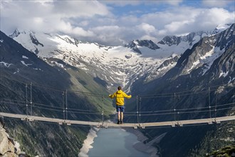 Mountaineers on a suspension bridge, picturesque mountain landscape near the Olpererhuette, view of