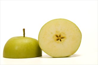 Close-up of a fresh green apple cut in half isolated on white background and copy space