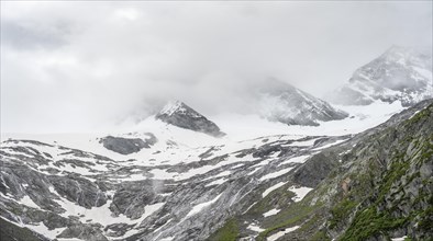 Cloudy and glaciated mountain peaks Hoher Weiszint and Dosso Largo with glacier Schlegeiskees,