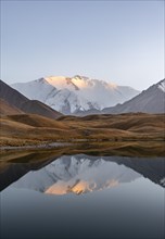 Mountain landscape at sunset, mountains reflected in a small mountain lake, Pik Lenin, Trans Alay