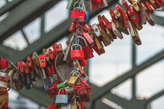 Many red love locks attached to a bridge construction, Hohenzollern Bridge, Cologne Deutz, North