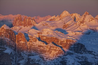 View of high plateau and mountains in the snow at sunset, winter, view of Geisler peaks, Dolomites,
