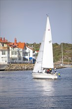Swedish sailing boat and the archipelago island Kooen, Marstrand, Vaestra Goetalands laen, Sweden,