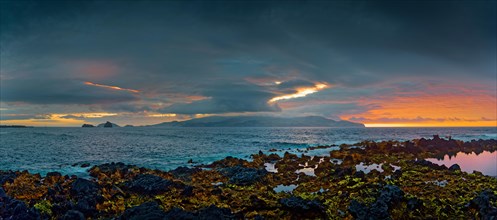 Extensive volcanic coastal landscape of Madalena at sunset with dynamic cloud formations, Madalena,