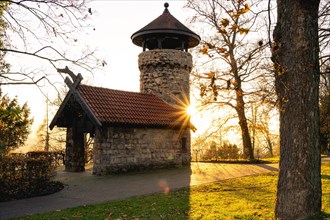 Historic tower backlit by the sunrise, surrounded by autumnal trees, Hachelturm, Pforzheim,
