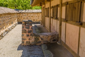 Buyeo, South Korea, July 7, 2018: Stone and mud chimney attached ancient house in traditional
